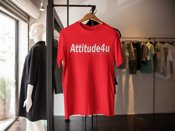 A red t-shirt hanging in a store with the company name Attitude4U mentioned on it.