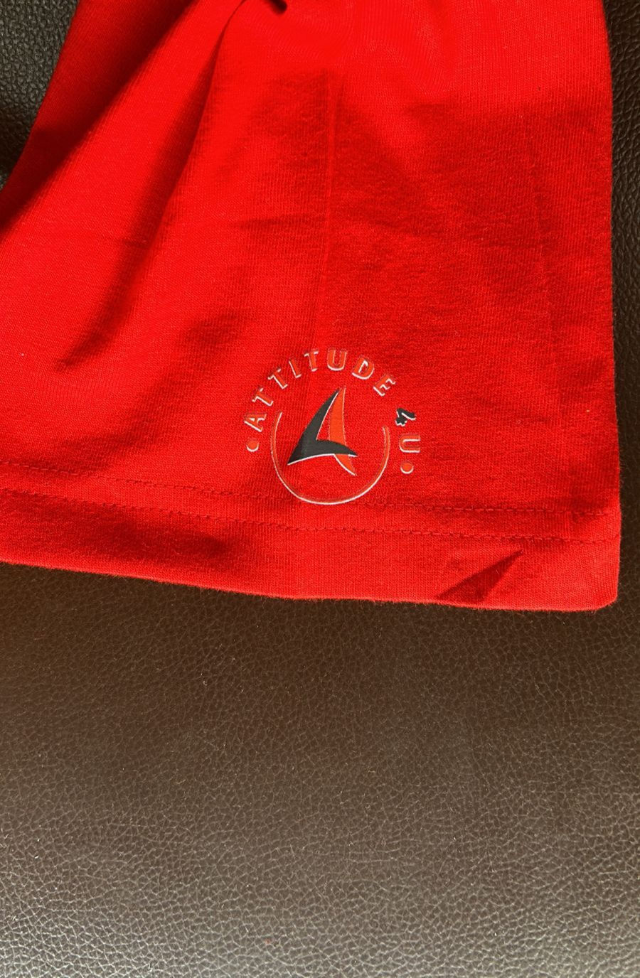 Thumbnail: red t-shirt with company logo graphic on sleeve