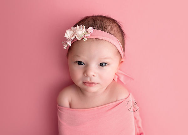Baby girl on pink background
