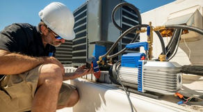 HVAC Tech working on a rooftop unit. Checking to make sure that the freon levels are good and the proper temperatures are coming out.
