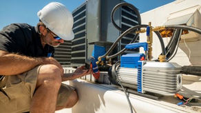 HVAC Tech working on a rooftop unit. Checking to make sure that the freon levels are good and the proper temperatures are coming out.