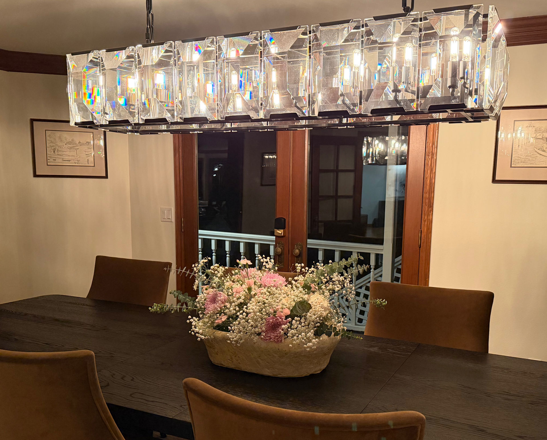 bachelorette party dinner location. Wood table, large chandelier and floral centerpiece