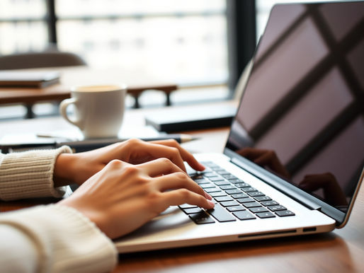 Executive typing a company update informing clients of accomplishments and achievements from the year