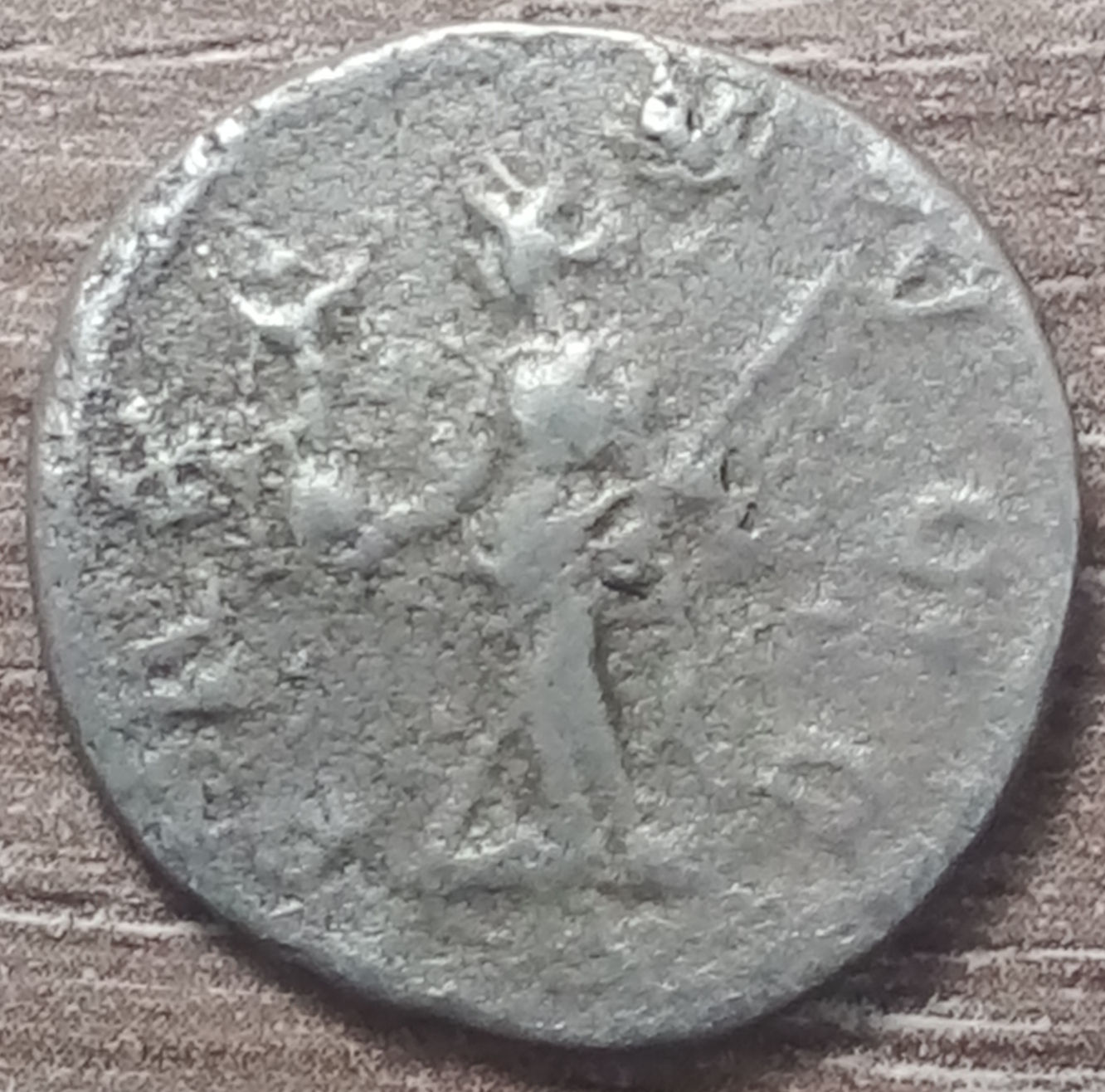 Ancient Roman coin showing a figure holding a spear, Originally Ancient Coin