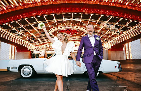 Bride & Groom celebrate their vow renewal outside Circus Circus with colorful bright lights