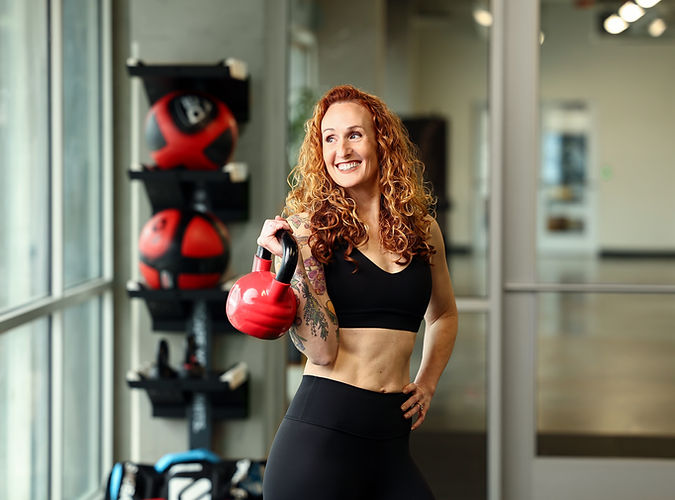 Fitness coach holding kettlebell.