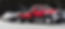 Red tow truck towing a white car