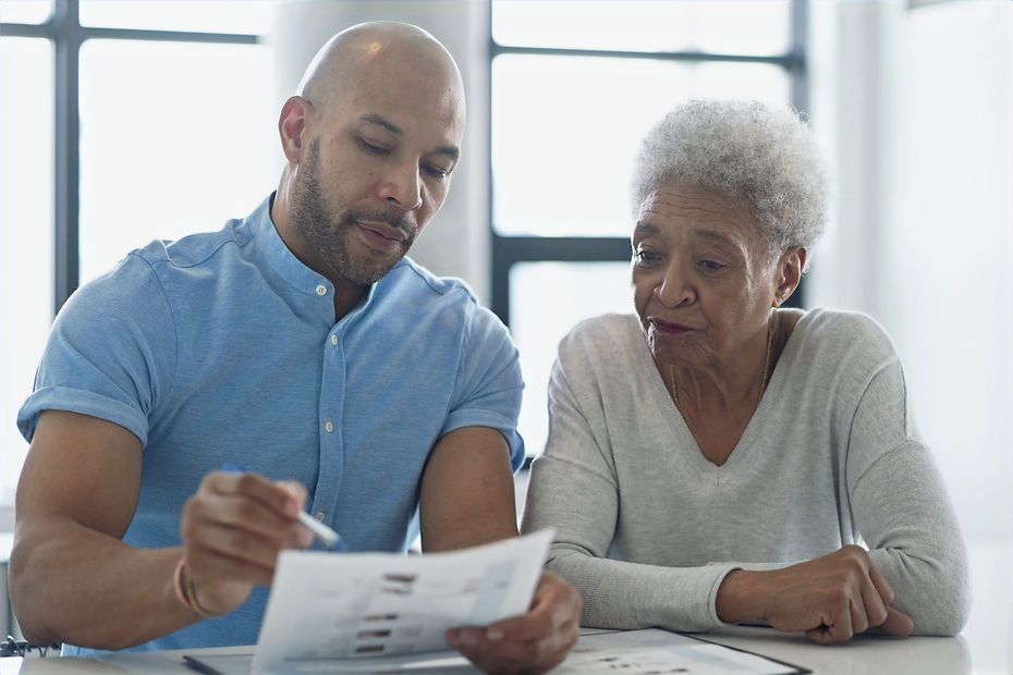 Veteran police officer helping elderly with paperwork