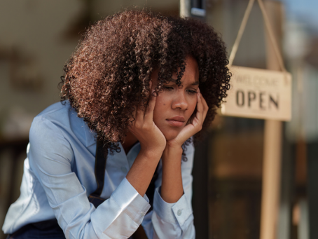 Image of Black woman working in an office — “Black professional woman in the workplace facing job cuts in 2025.”