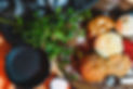 A large selection of gluten-free baked goods. Including a cinnamon roll, pumpkin roll, cupcakes, muffins, and cookies