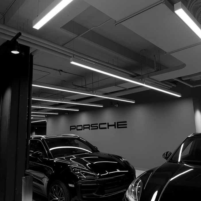 Two black cars at Porsche dealership in Kitchener