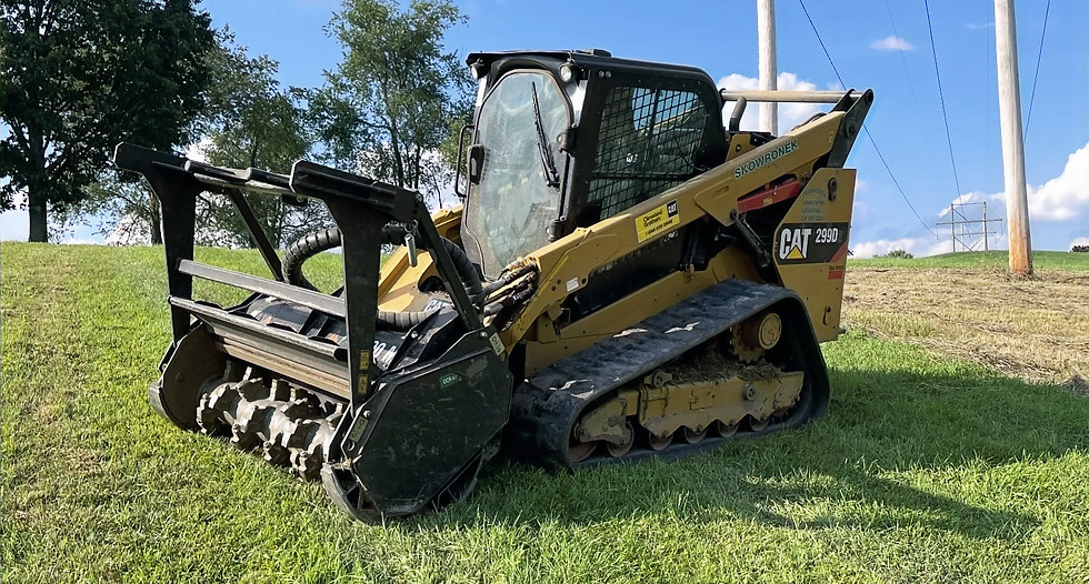 CAT 299D3 skid steer with forestry mulcher attachment clearing brush in Westmoreland County, PA.