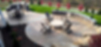 Patio with outdoor kitchen, firepit, and seating wall in Irwin, PA by Skowronek Landscaping & Excavating.