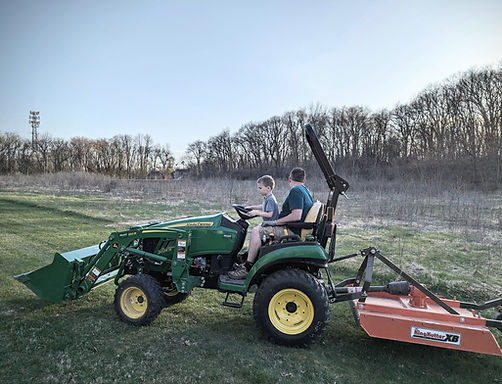 tractor mowing flower field with dad and boy