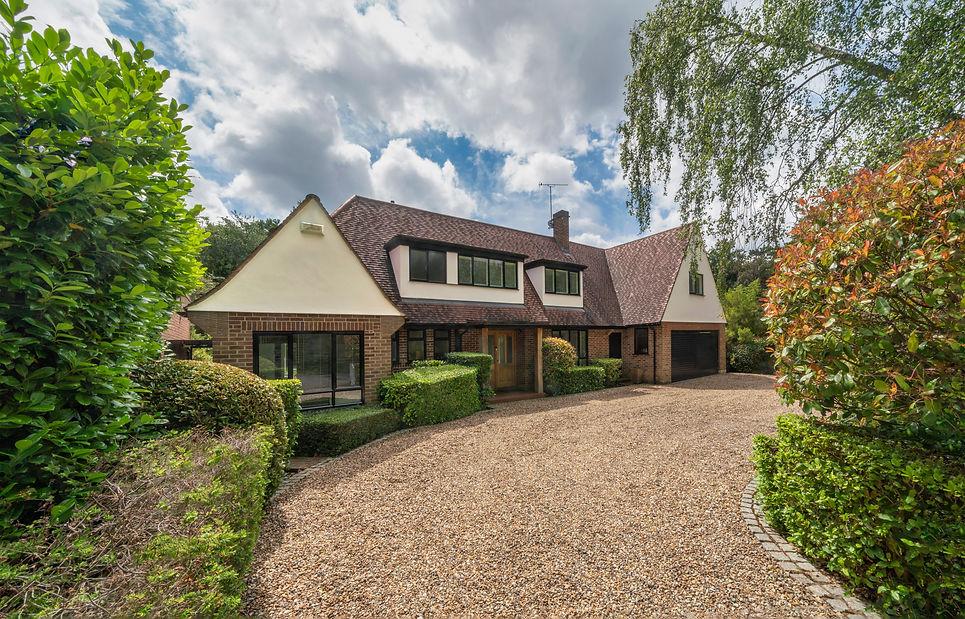 Beautiful detached house with gravel drive and shrubs on summer day..jpg