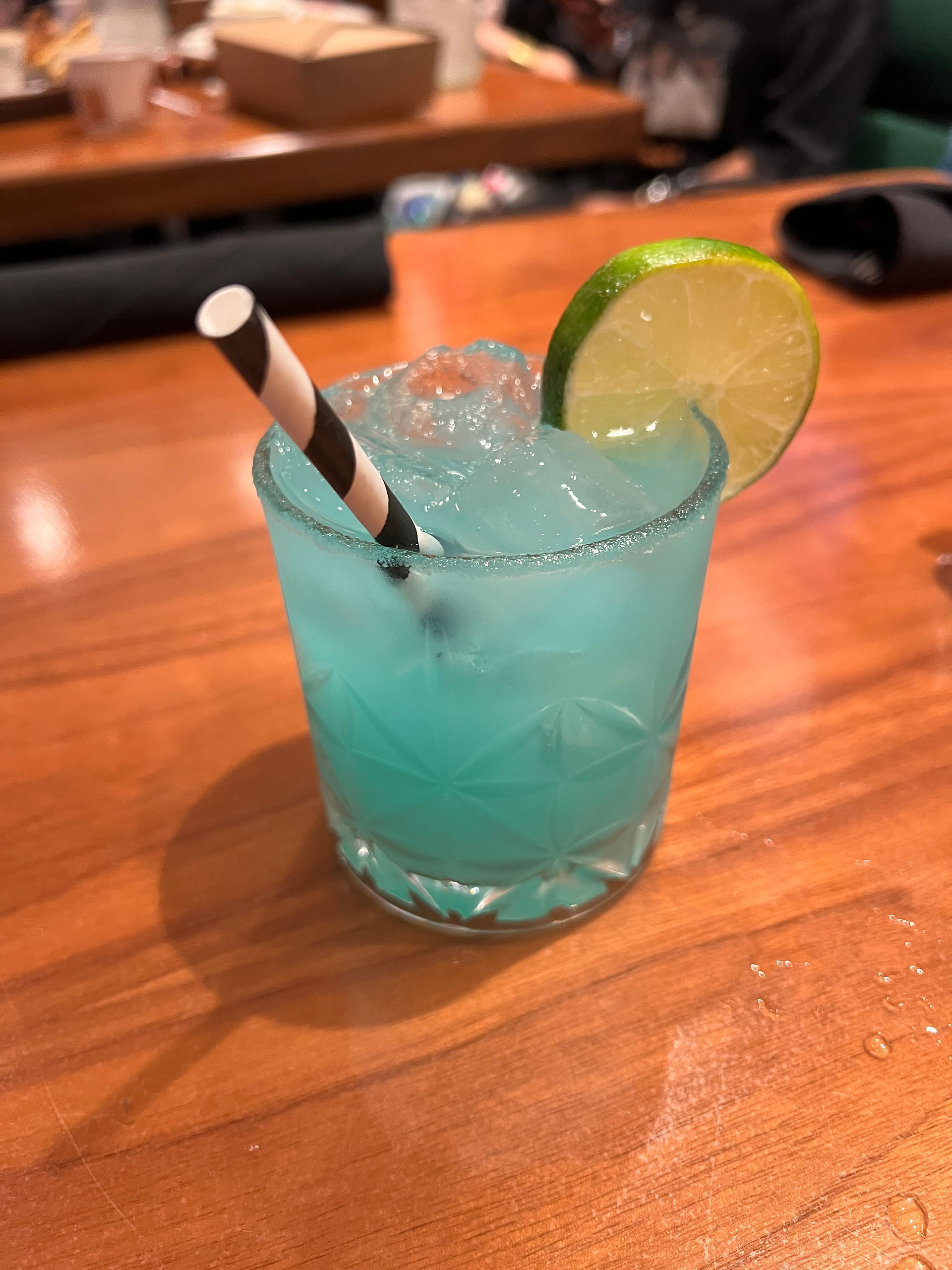 Adult Kool-Aid which is Caribbean blue and served with a slice of lime and a paper straw.