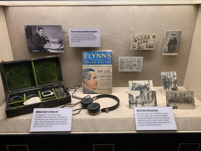William Flynn's wiretap kit to the left, Flynn's autobiography in the middle, and Black Hand trial postcards to the right.