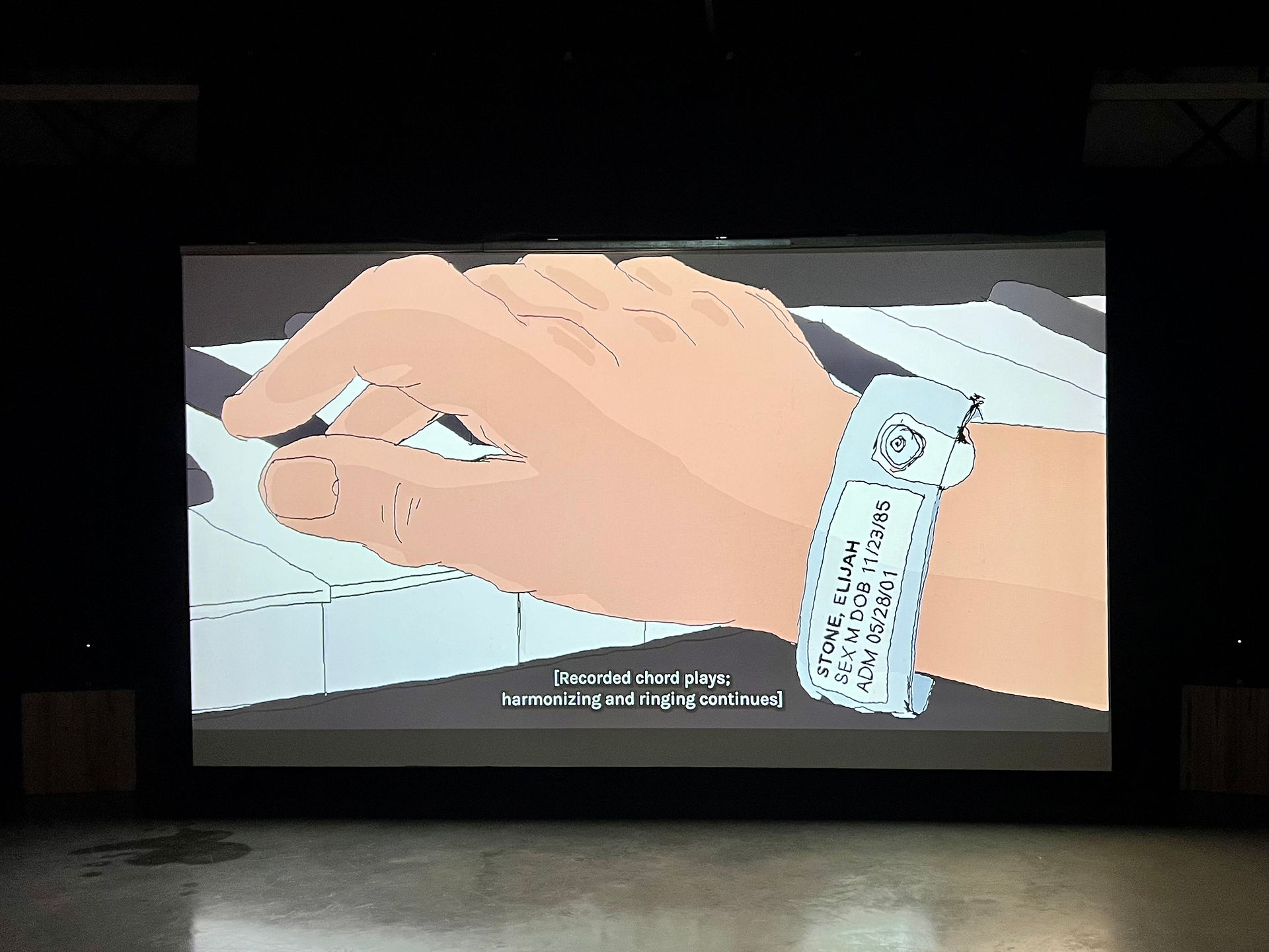 ELI is a short film by Nate Milton. Image features the hand of the main character, Eli, who is wearing a medical band from a hospital as he plays the piano.