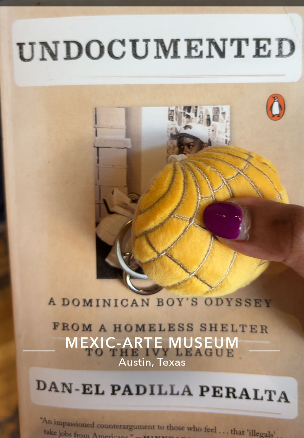 Close-up of a book titled "Undocumented" by Dan-el Padilla Peralta, with a yellow concha keychain. Text: Mexic-Arte Museum, Austin, Texas.