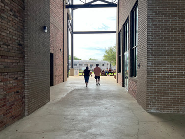 Walking up to the train through a breezeway made of brick