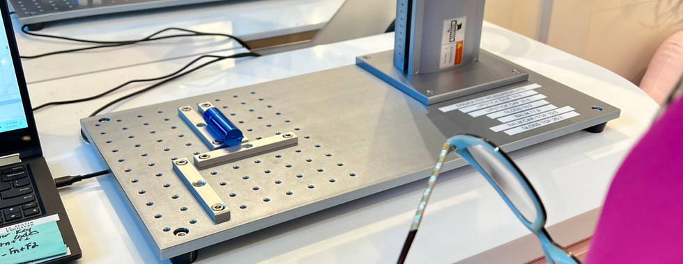 Lip Lab Laser machine etching text onto a blue lipstick tube.