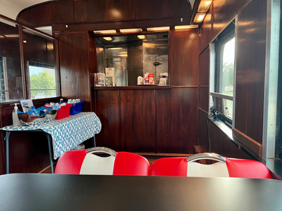 Diner-style seating with a view of the wood paneled bar with refreshments