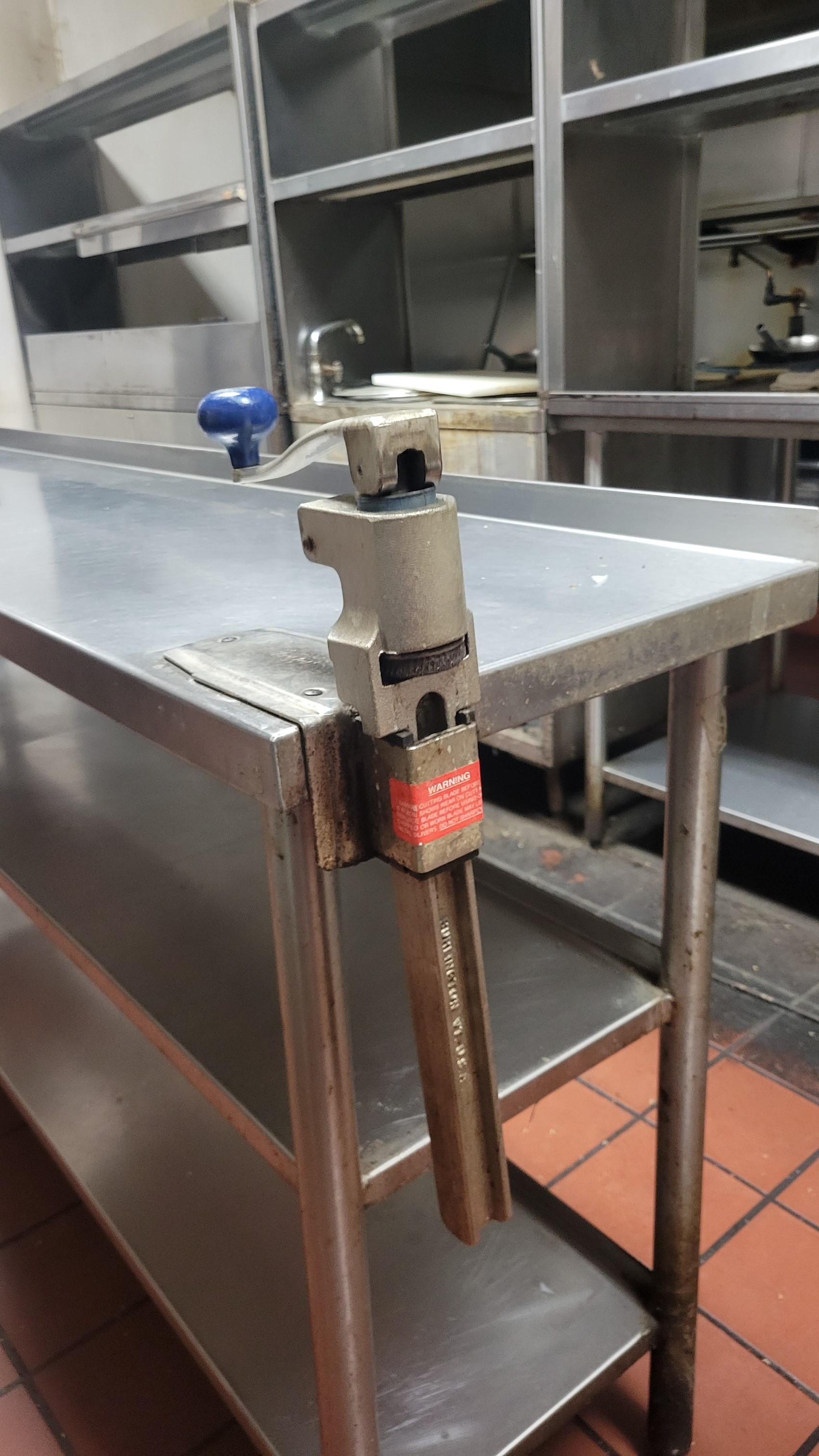 Stainless steel work table with 3 undercounter shelves With Edlund can opener (7
