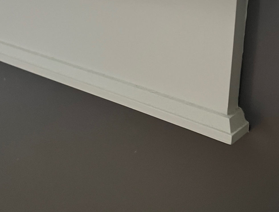 White baseboard against a gray wall, simple design with no visible text or objects, conveying a minimalist and clean aesthetic.