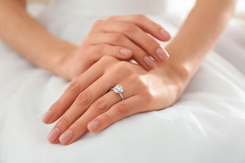 Young bride wearing beautiful engagement ring, closeup.jpg