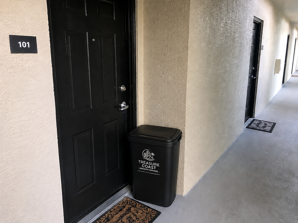 Black bin for doorstep trash collection outside apartment 101