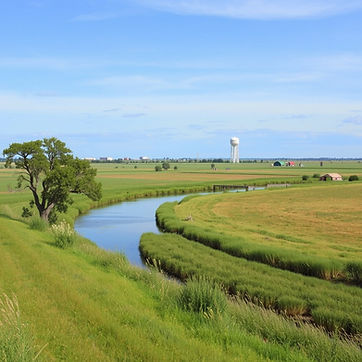 kansas landscape with a river and a water tower off in the distance.jpg