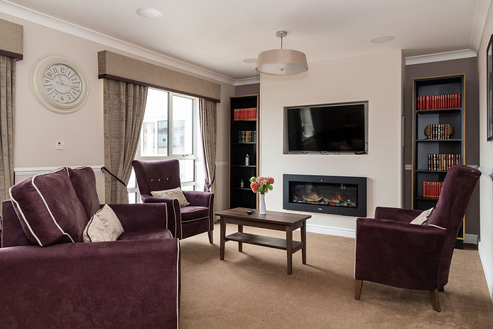 Wellen court nursing home lounge with comfortable chairs and warm fireplace