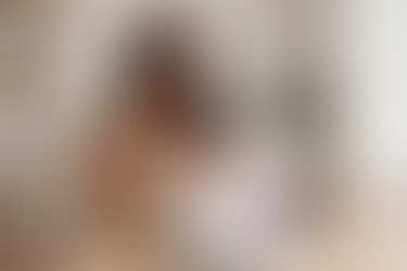 Confident Black woman business owner reviewing documents at her desk while planning business growth.