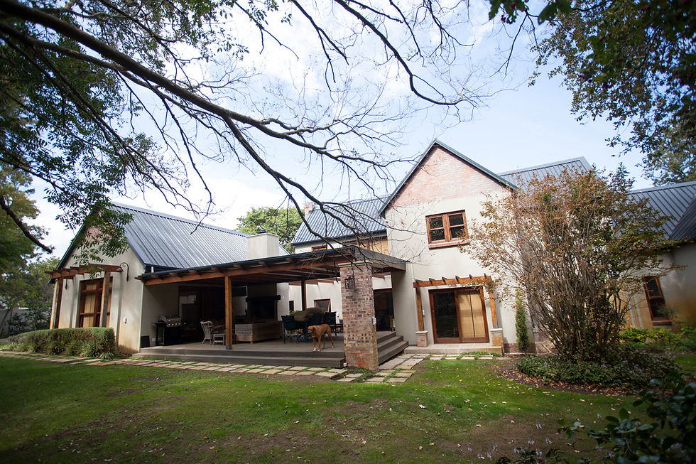 Backyard patio with brick column, grill, and landscaped garden