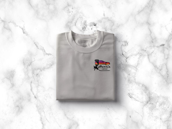 Harris Company logo on a folded gray crewneck swetahirt lying on a white and gray marble background