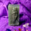 Thumbnail: Green Venus Soap bar with a detailed sculpture on purple cloth background.