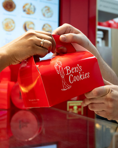 Red box labeled "Ben's Cookies" being handed over.