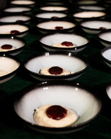 Bowls with white dessert and red topping.