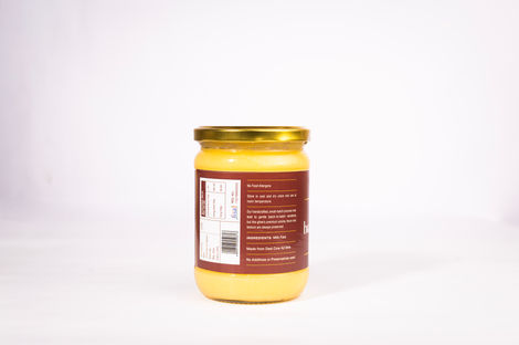 A jar with a golden lid and brown label.