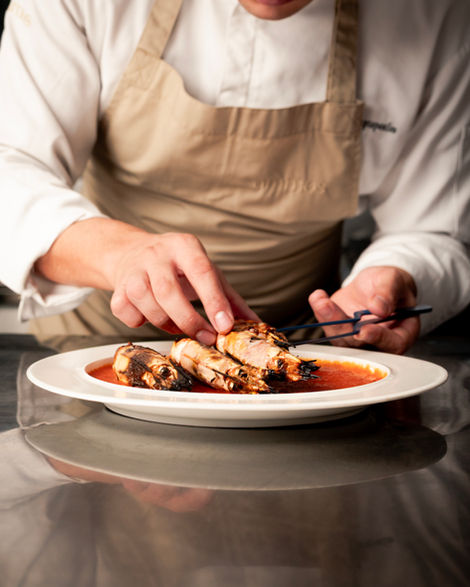 Chef plating dish with precision and care.