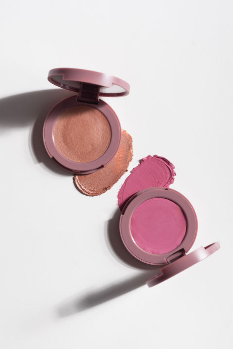 Two open makeup compacts with blush colors.