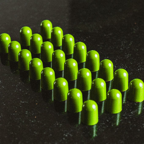 Green capsules arranged in a grid pattern.