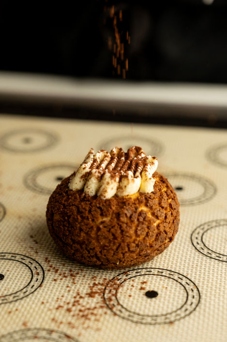 Cream-filled pastry on a patterned surface.