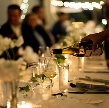Intimate lighting reflecting on wedding guests faces.