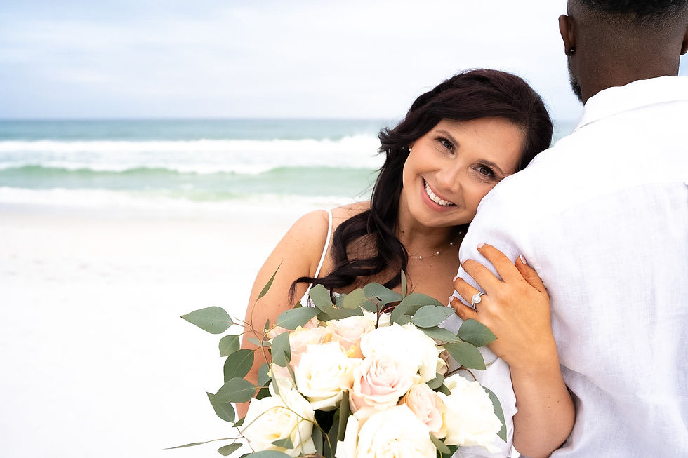 Newly married couple with bride resting her head on groom's shoulder.