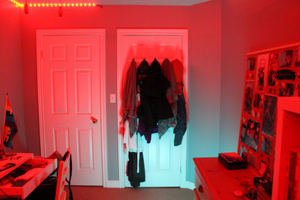 a photo with teal and red lighting of a door