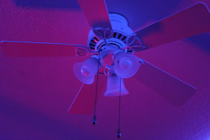 a photo with pink and blue lighting of a ceiling