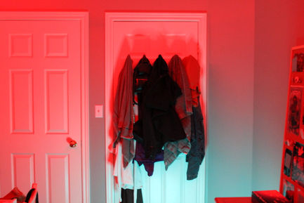 a photo with teal and red lighting of a door