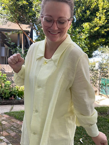 A mid-sized white woman wearing a yellow cotton voile from the selvedge societyshirt dress Belle from peppermint magazine spoonflower indy sewing pattern from modern sewing Co