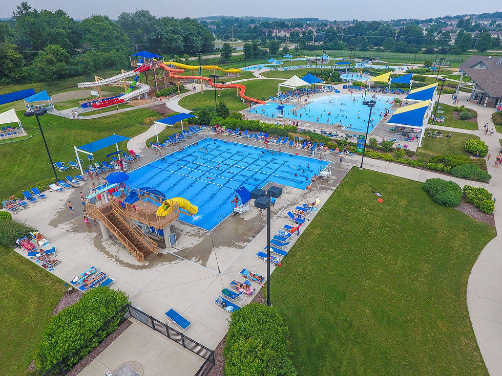 Arial photo of Otter Cove Water Park featuring a lap pool, zero depth entry pool, water slides, lazy river, lounge chairs, and more all within the St. Charles Park District.